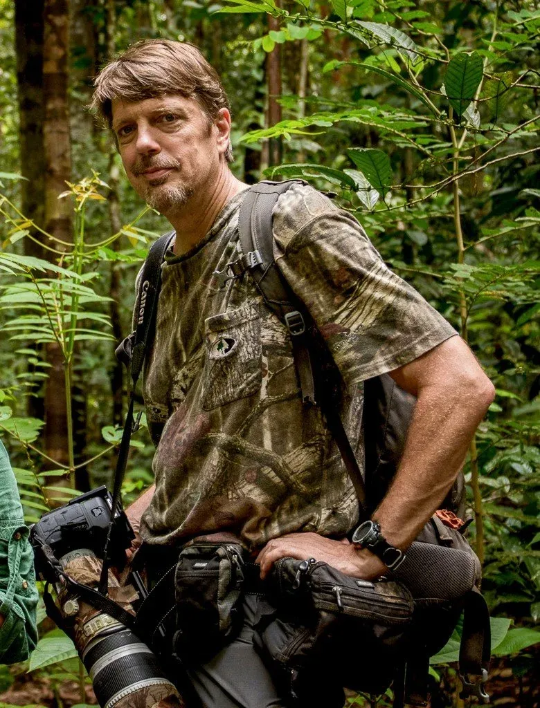 Tim Laman in the field with a telephoto lens
